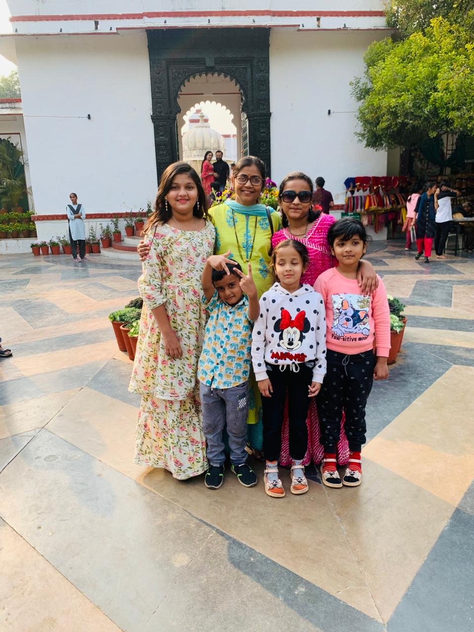 Family travelers smiling at a palace courtyard