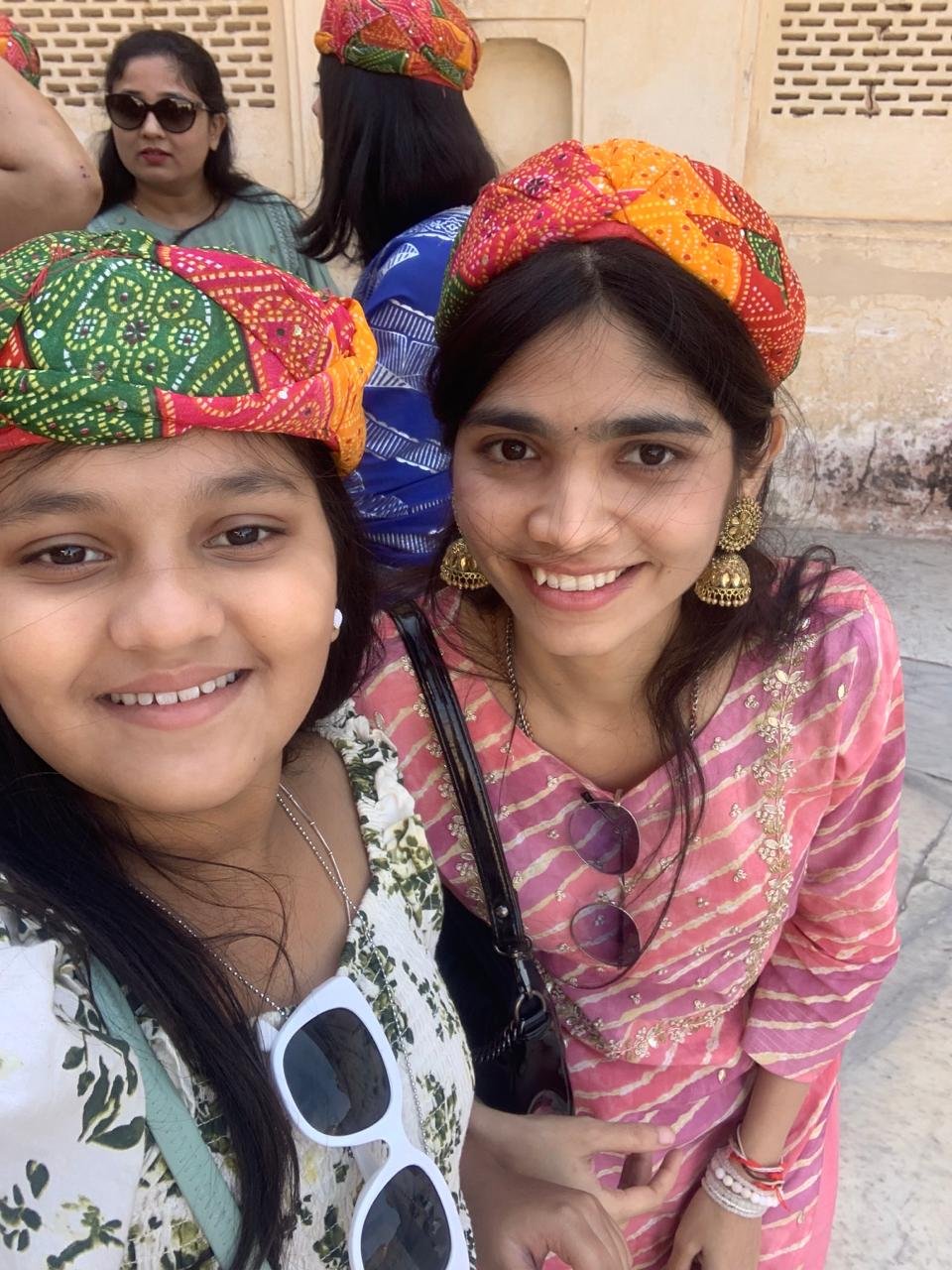 Two young travelers taking a selfie in colorful turbans