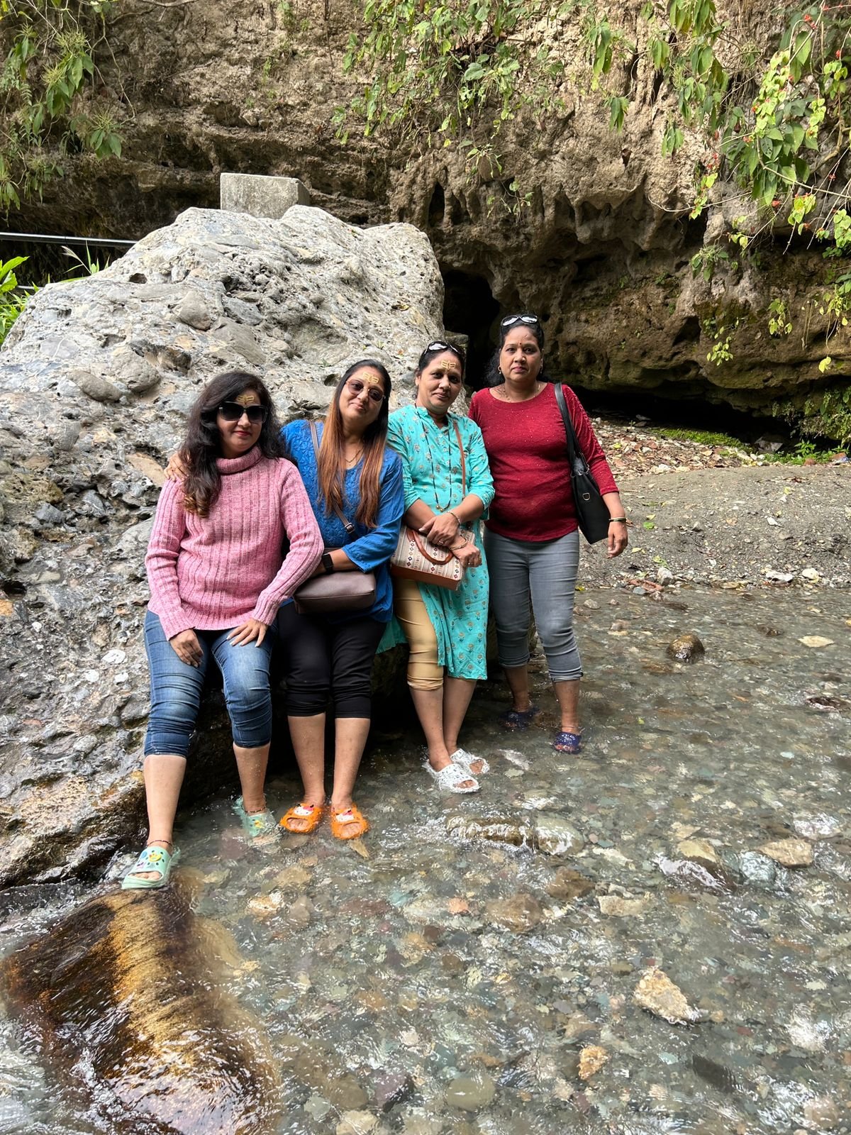 Travelers relaxing by a rocky stream